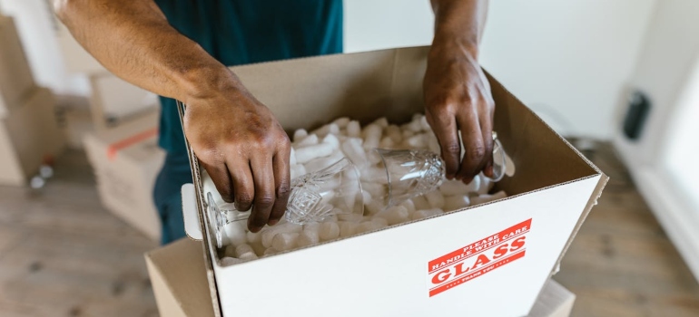 a man packing something in a box 